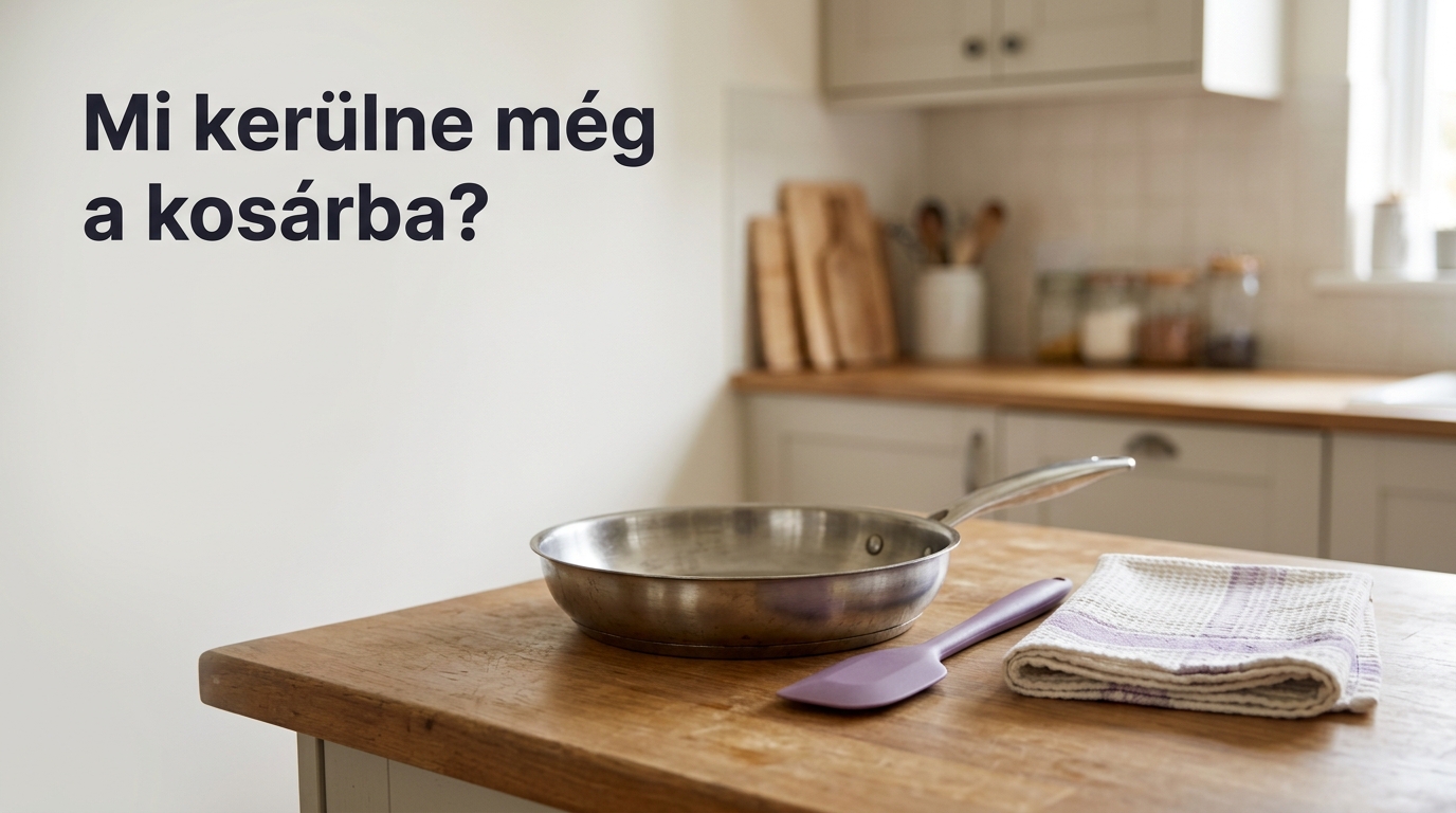 Rozsdamentes serpenyő, szilikon spatula és konyharuha egy otthoni konyhapulton